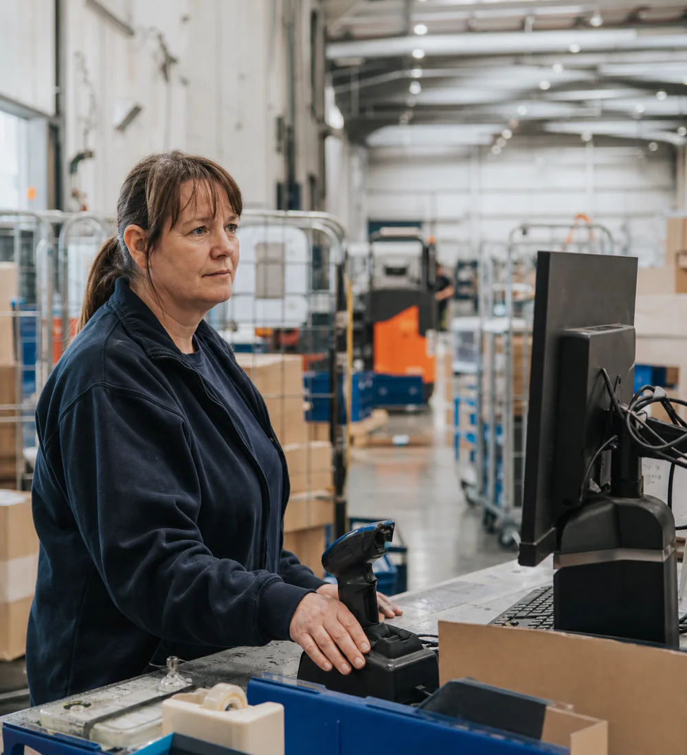 Warehouse supervisor reviewing the day at a dispatch workstation