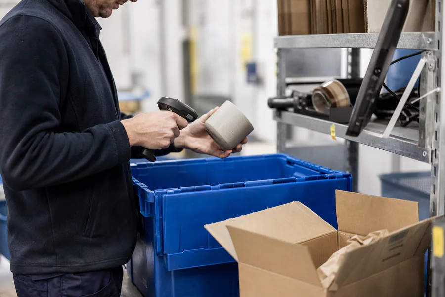 Operative scanning an item at the packing bench