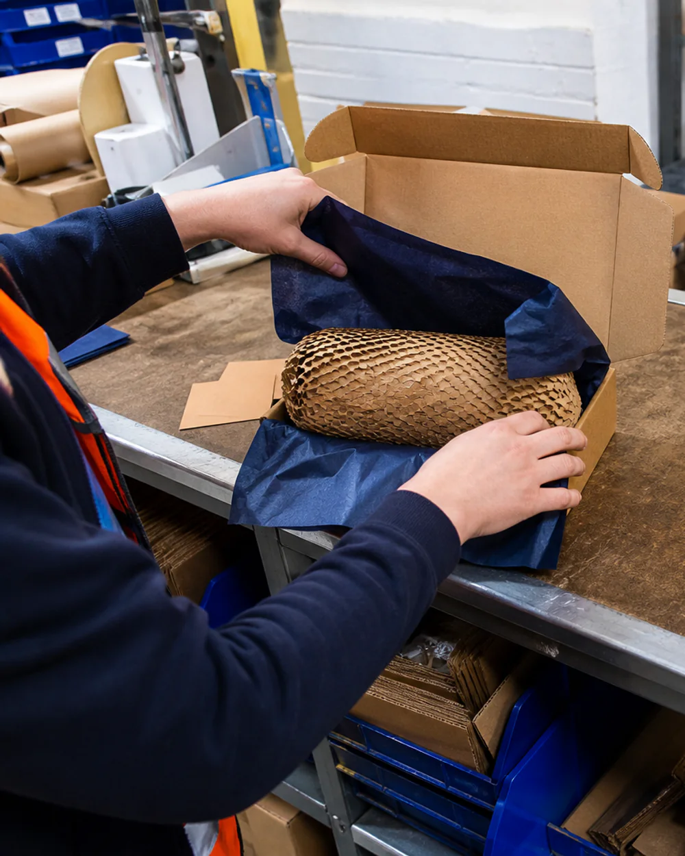 Operative assembling a subscription box to a documented packing specification